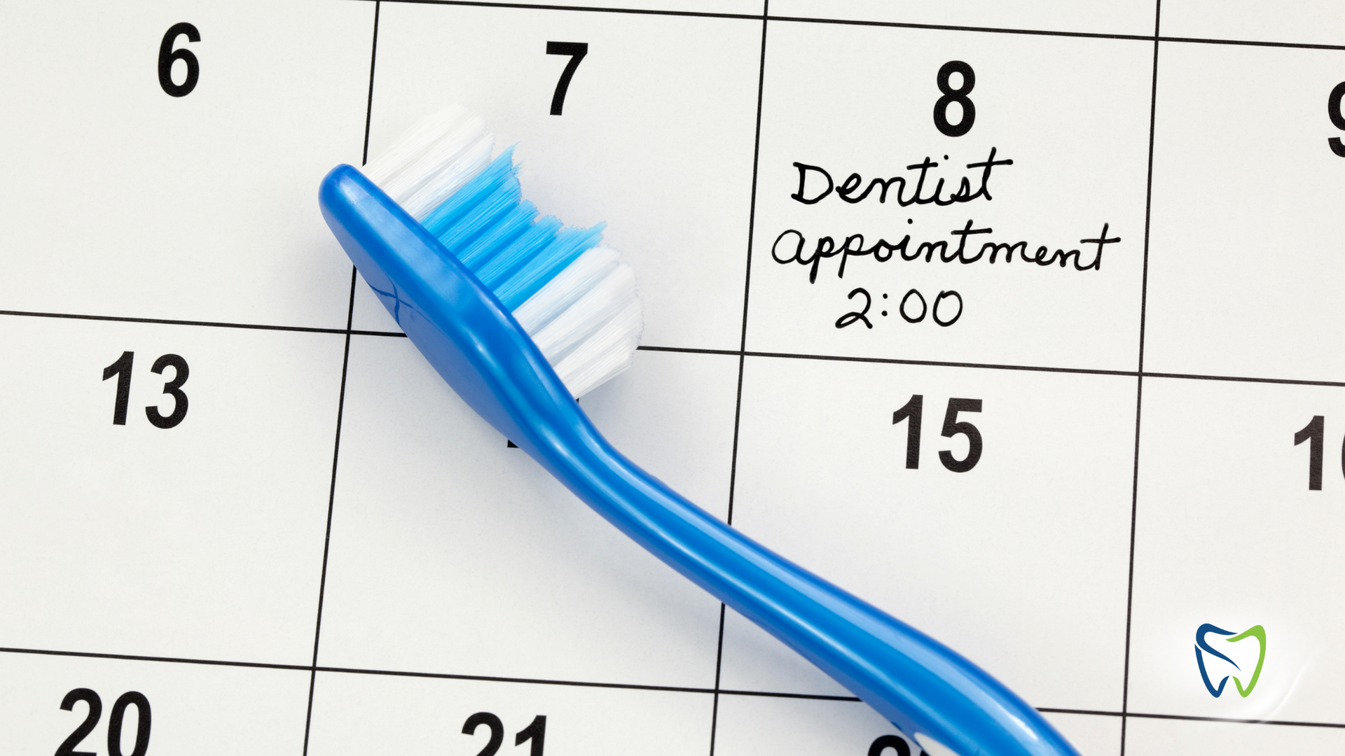 A blue toothbrush is on a calendar that says dentist appointment 2:00
