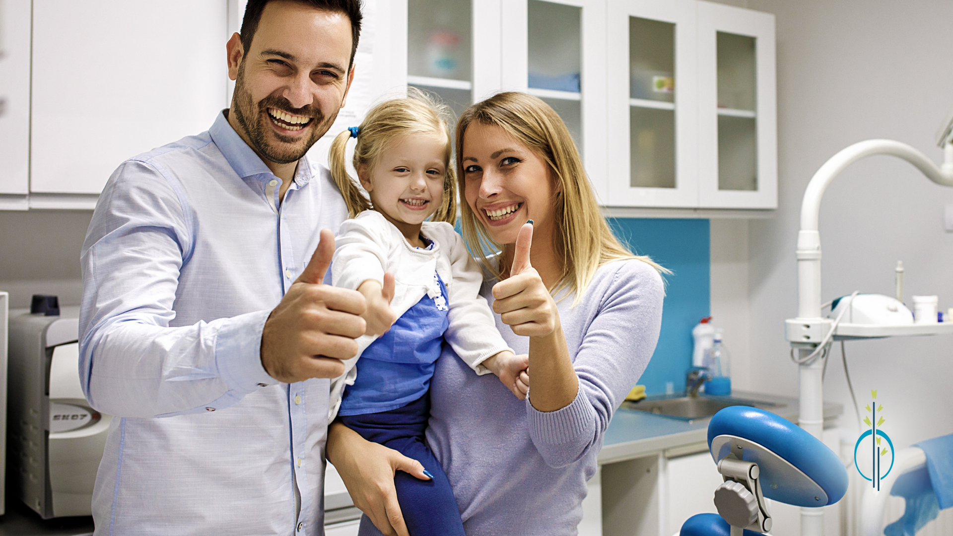 A family is giving a thumbs up in a dental office.