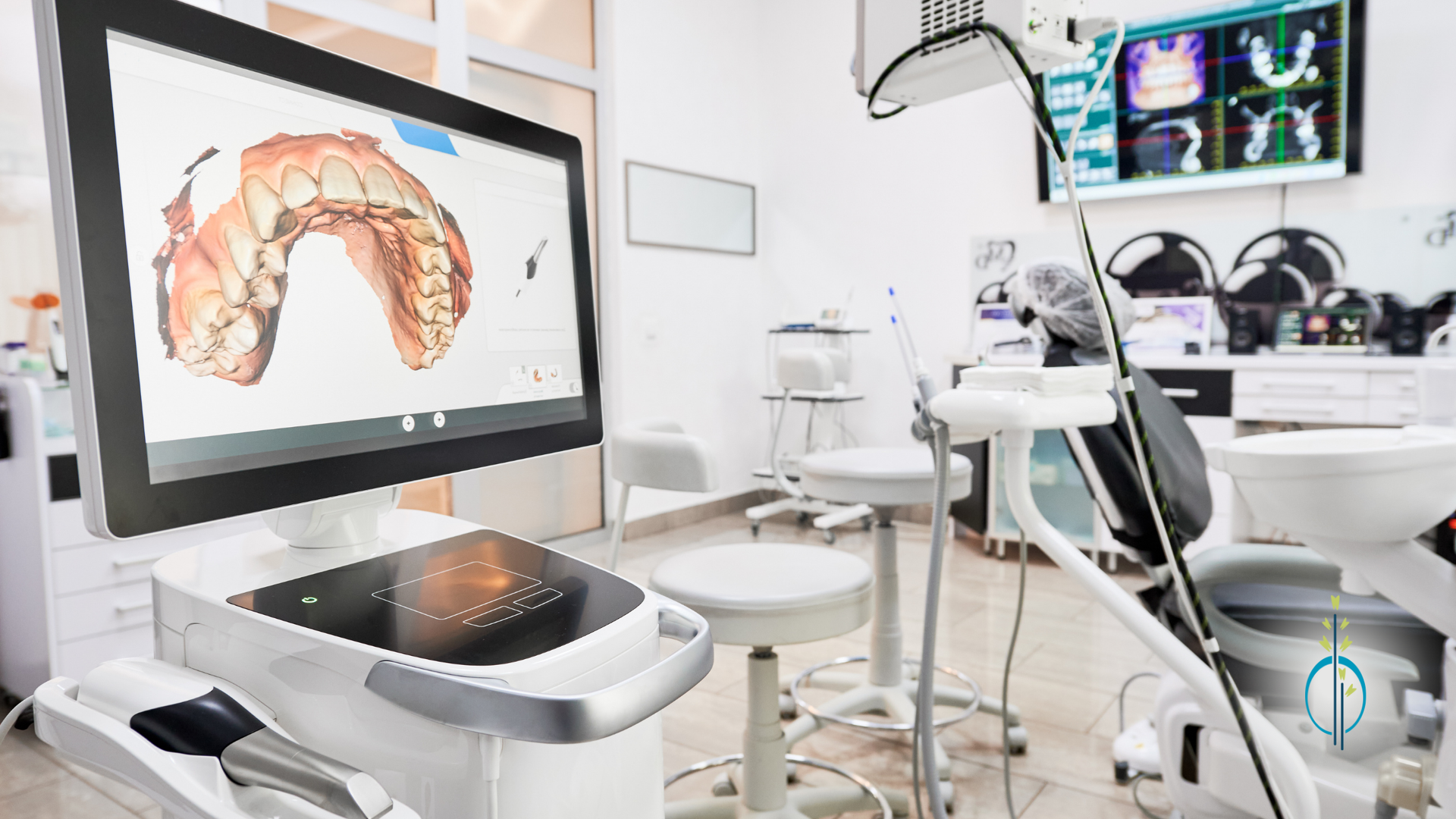 A dental office with a computer and a dental chair.