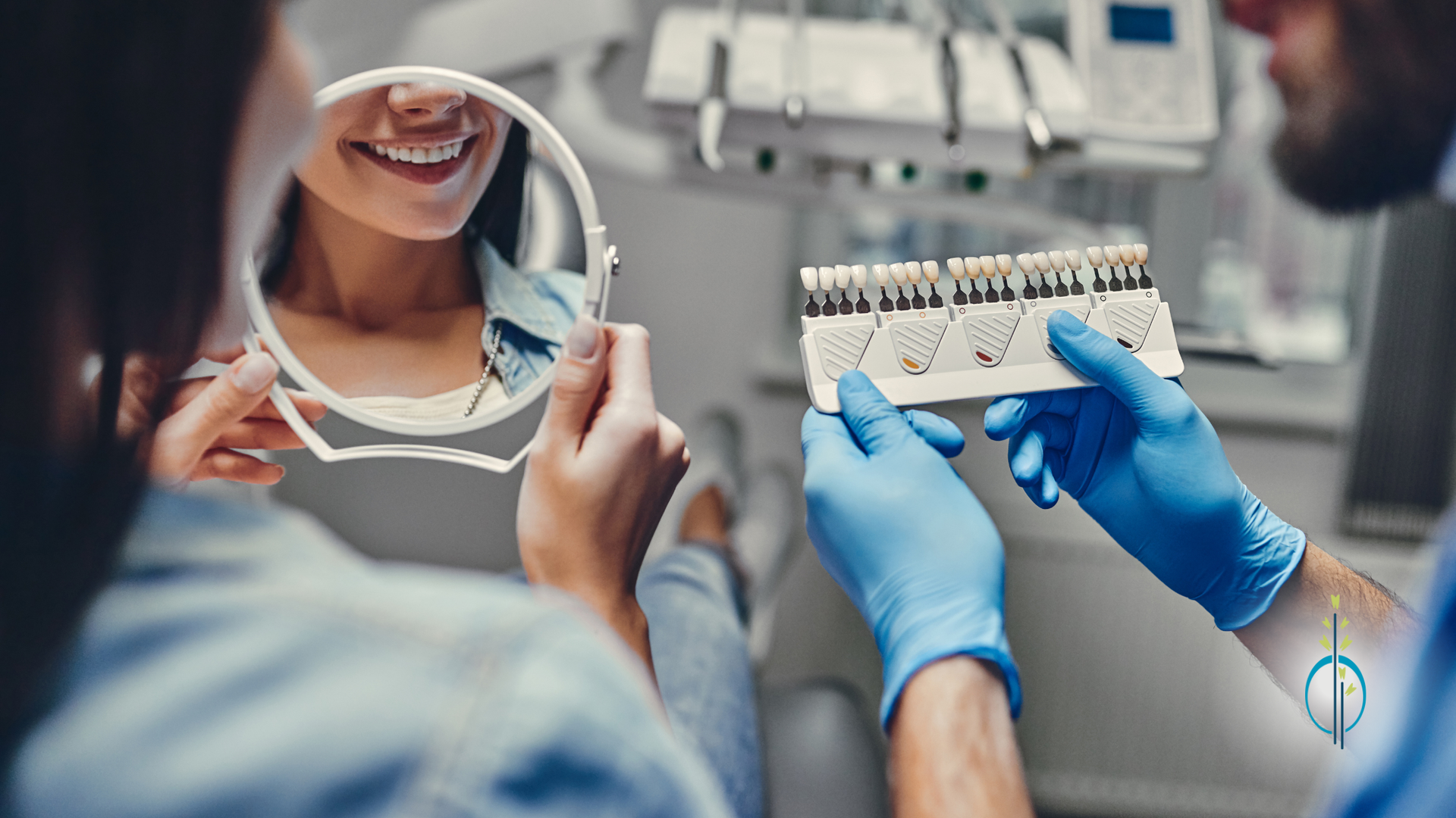 A dentist is holding a tooth color chart and looking at a woman 's smile in a mirror.