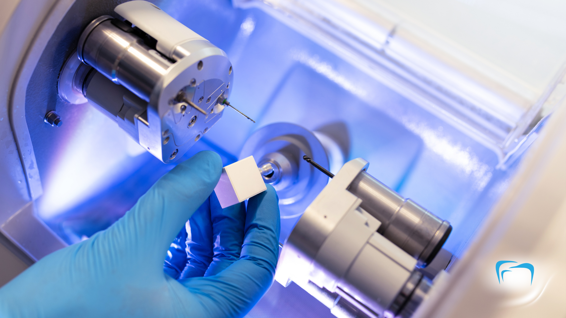 A person is holding a piece of plastic in front of a machine.