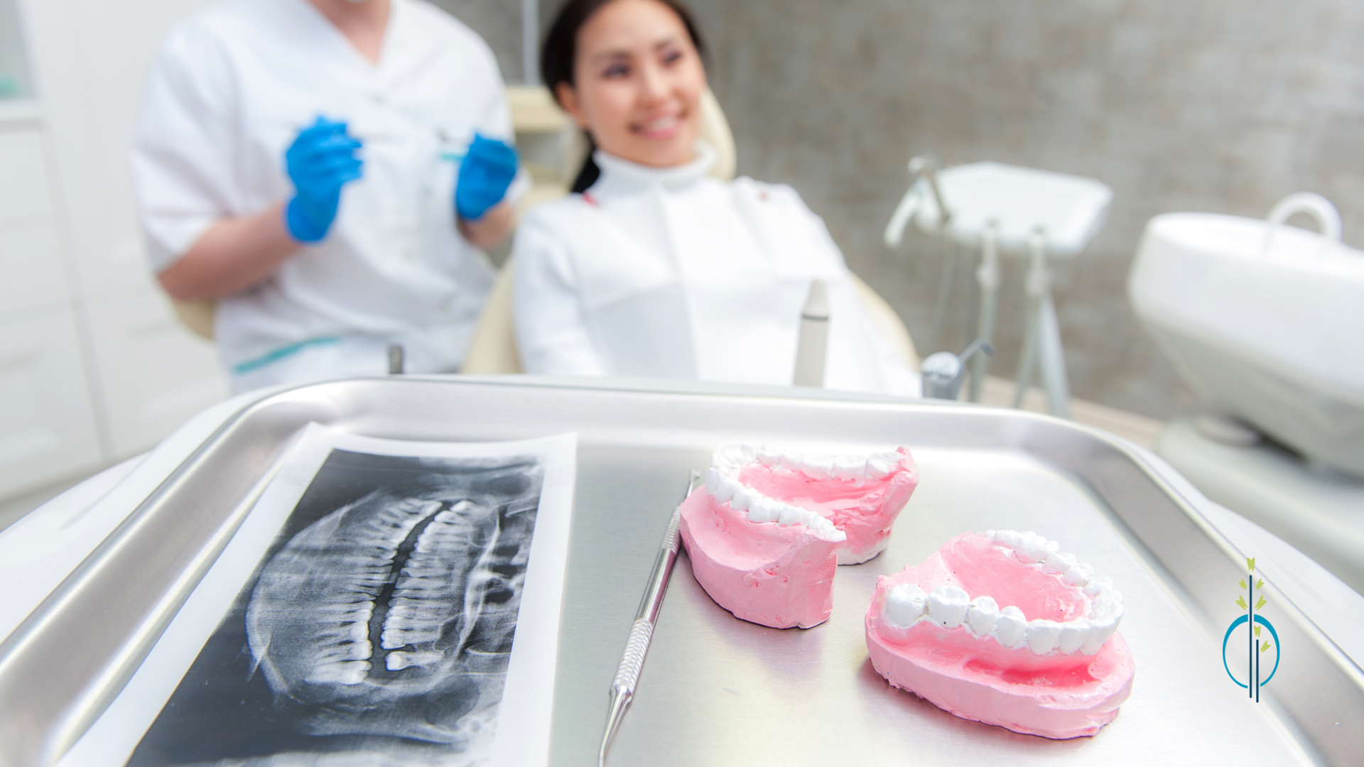 A woman is sitting in a dental chair while a dentist examines her teeth.