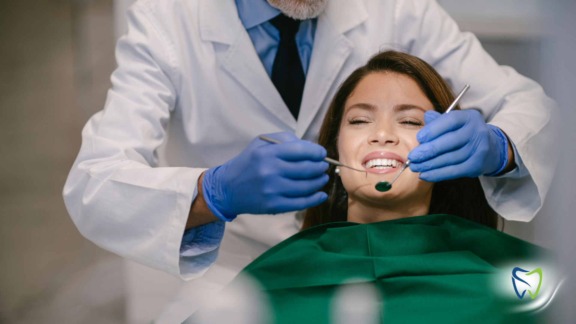 A woman is getting her teeth examined by a dentist.