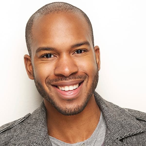 A man with a beard is smiling for the camera