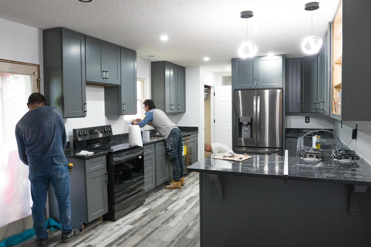 A couple of men are working in a kitchen.
