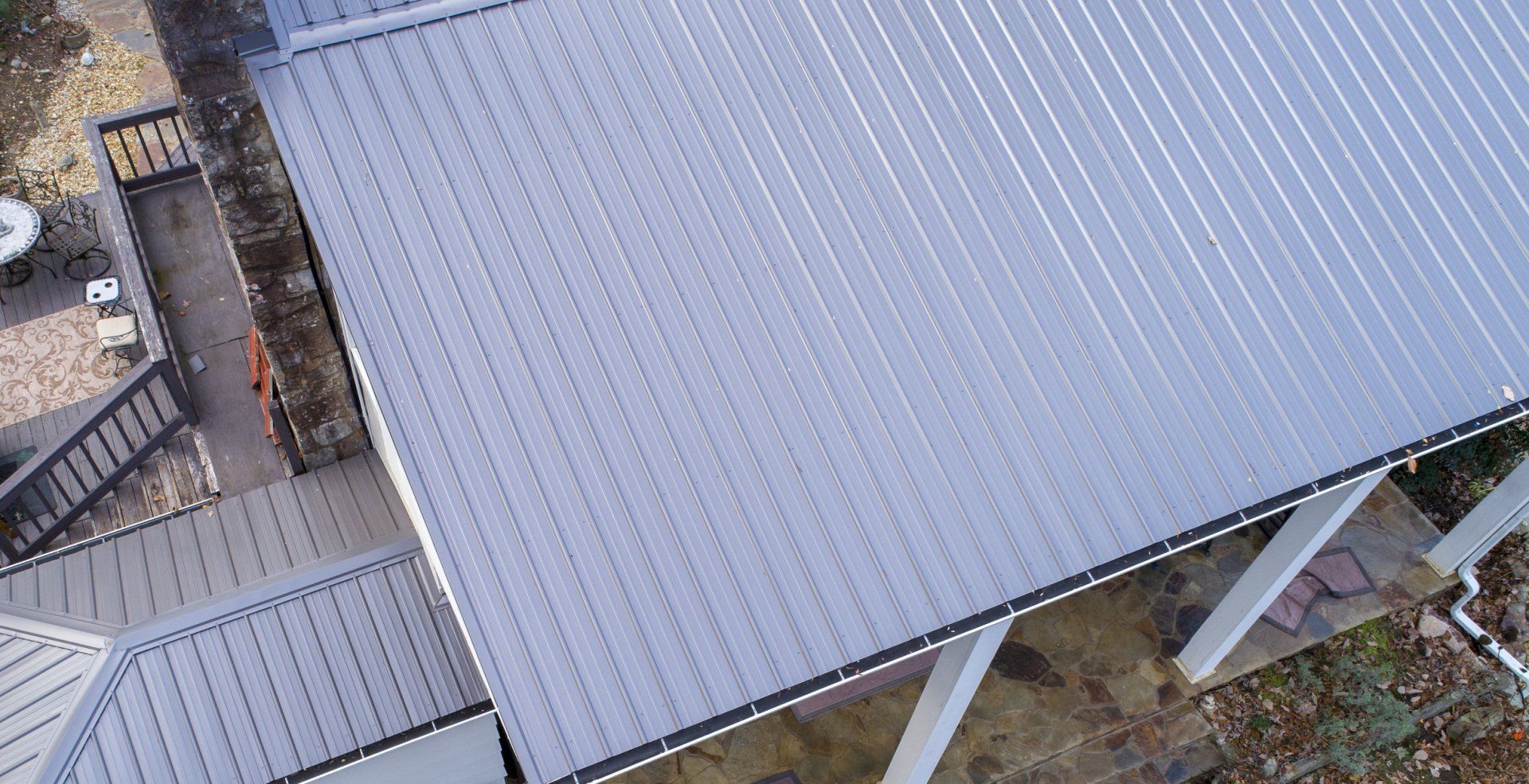 An aerial view of a house with a metal roof.