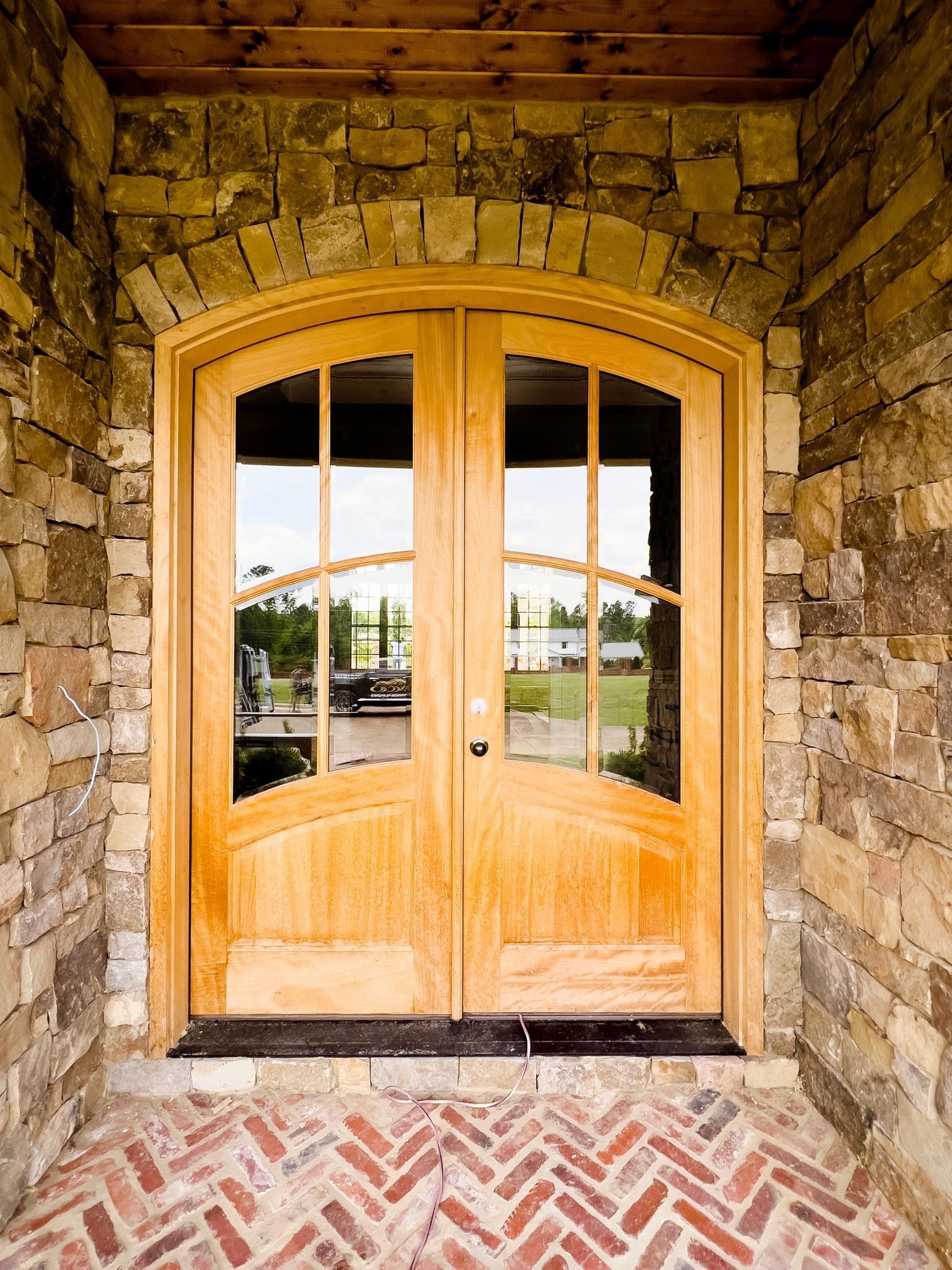 A wooden door with a stone wall behind it
