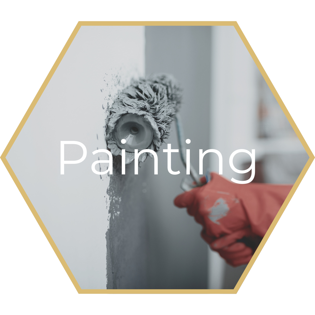A person wearing yellow gloves is cleaning a window with a sponge.