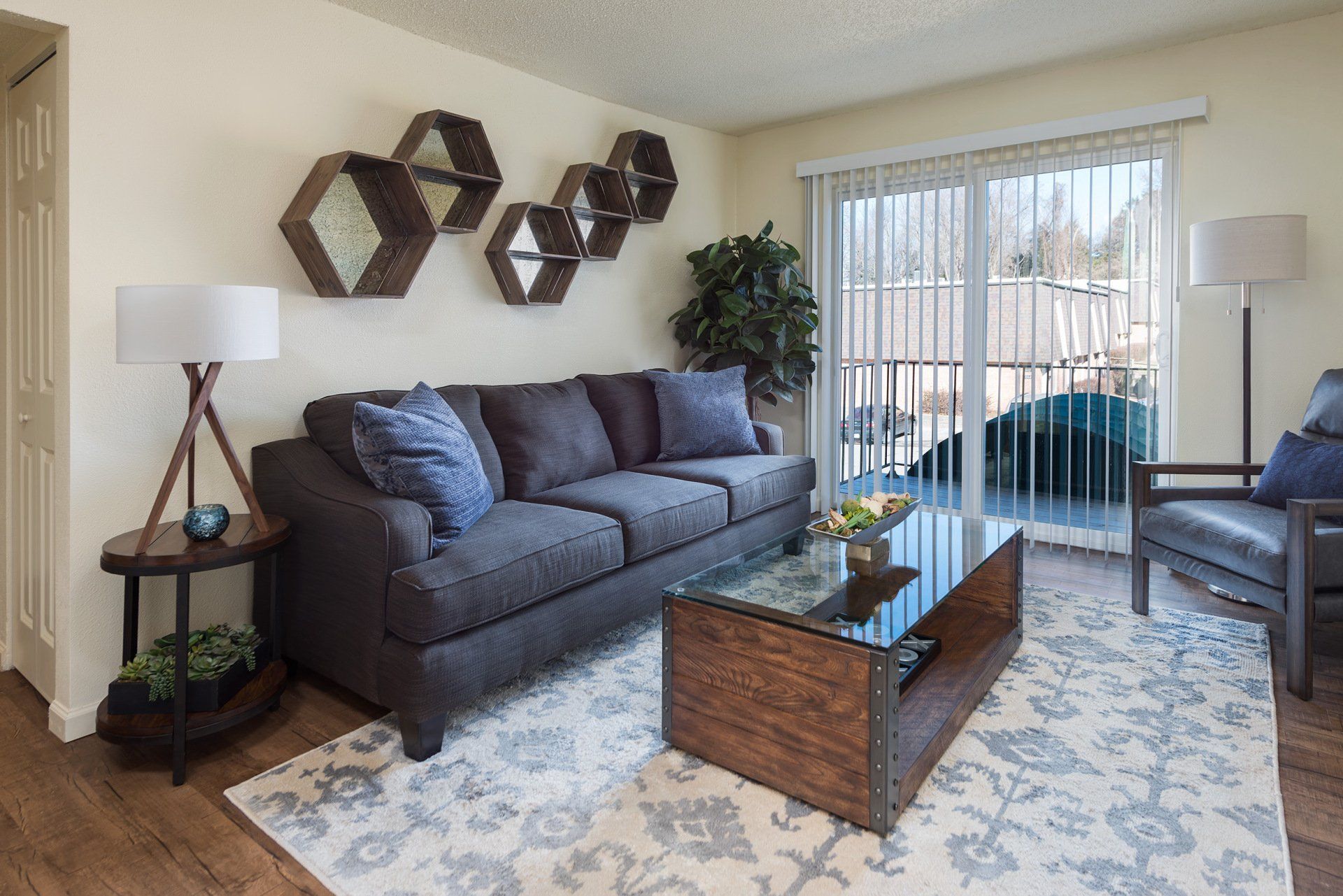 Westport Crossing Apartments apartment living room with sliding patio doors - staged.