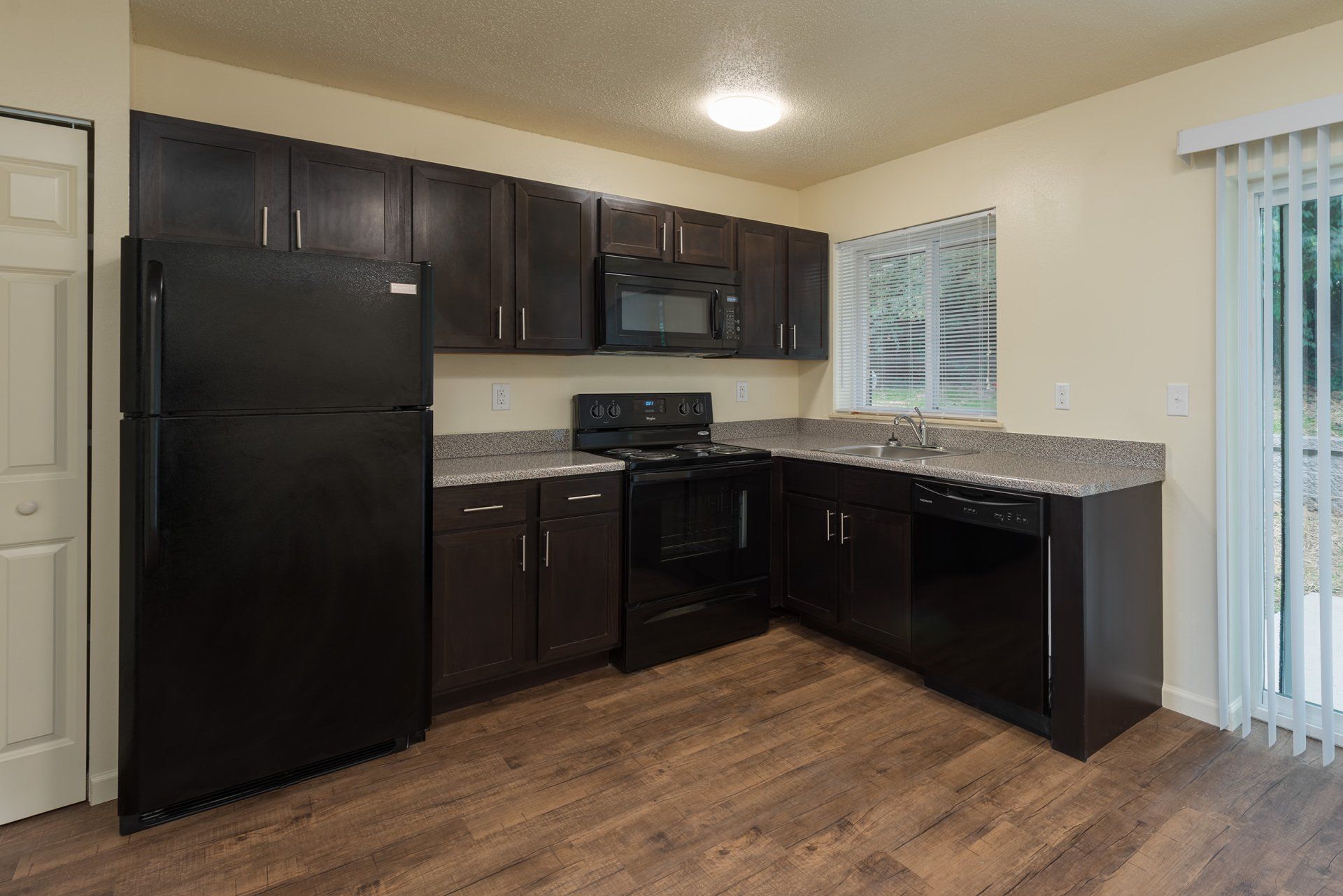 Westport Crossing Apartments kitchen with black refrigerator and stove.