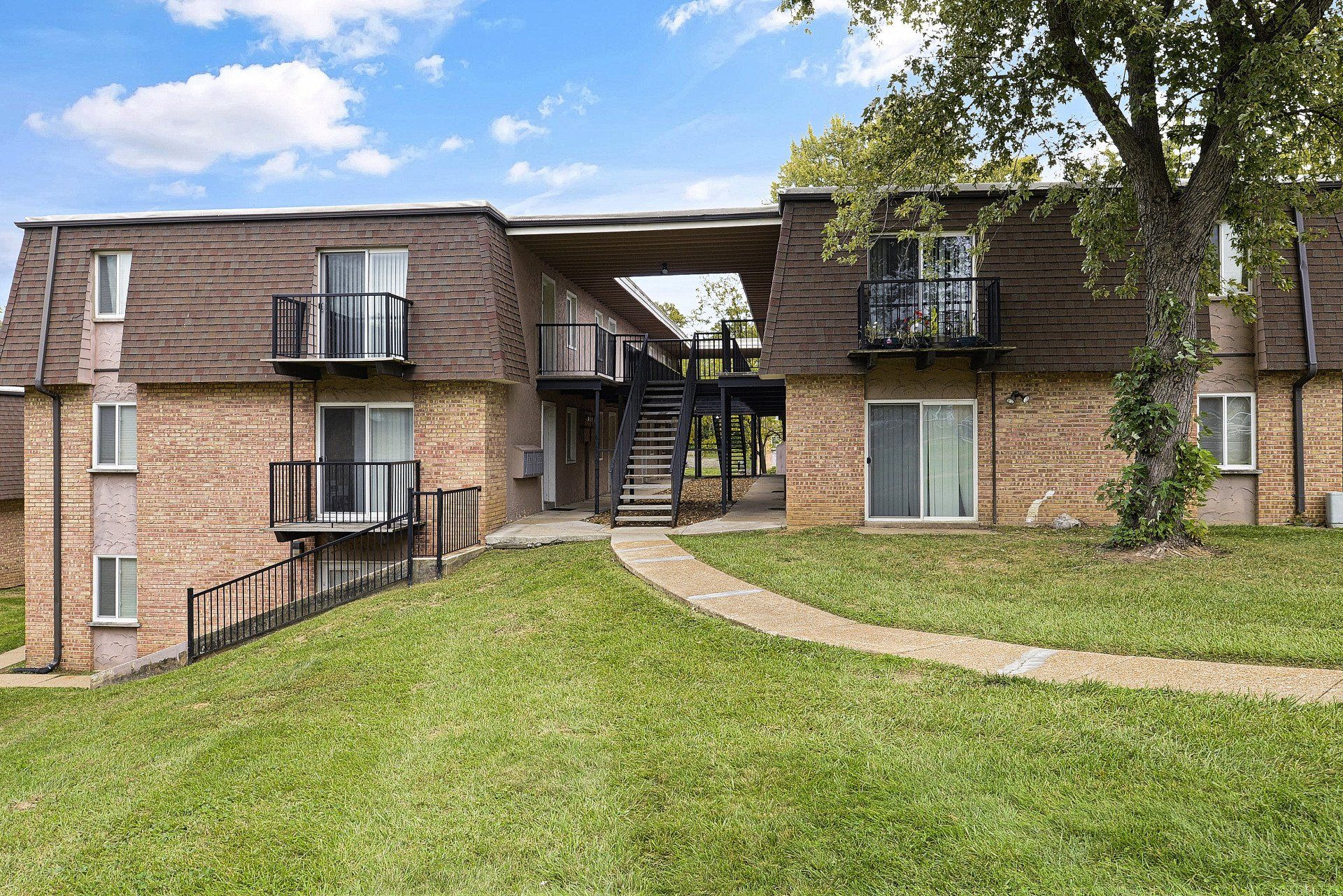 Exterior of Westport Crossing Apartments with large grass area and walkway