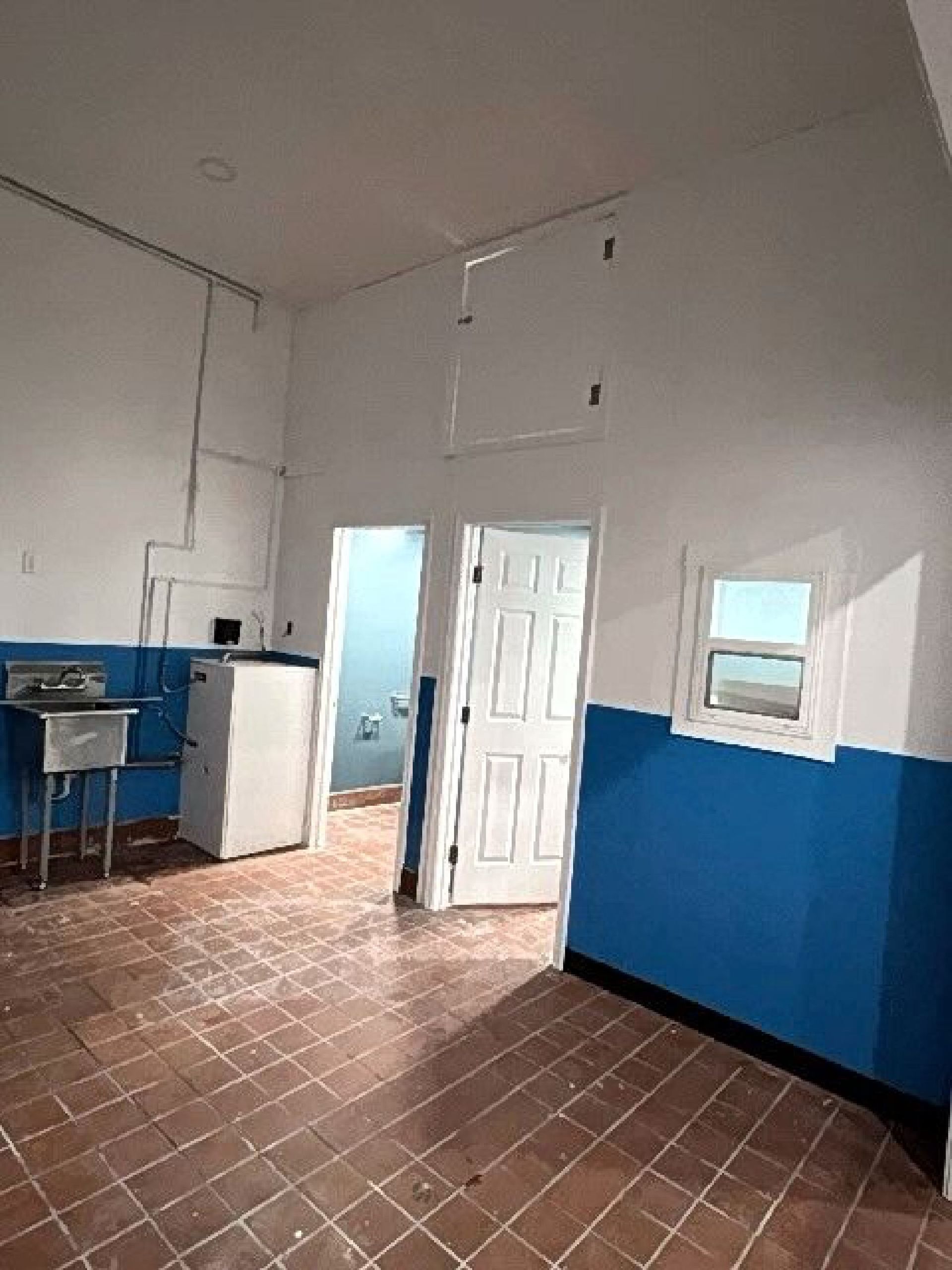 A room with blue and white walls and a sink
