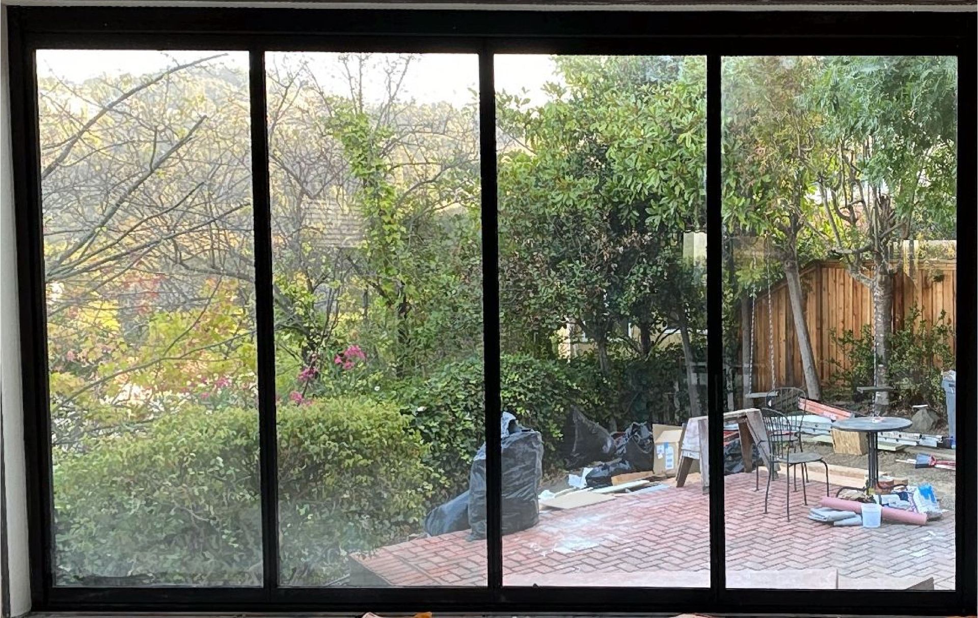 A view of a backyard through a sliding glass door.