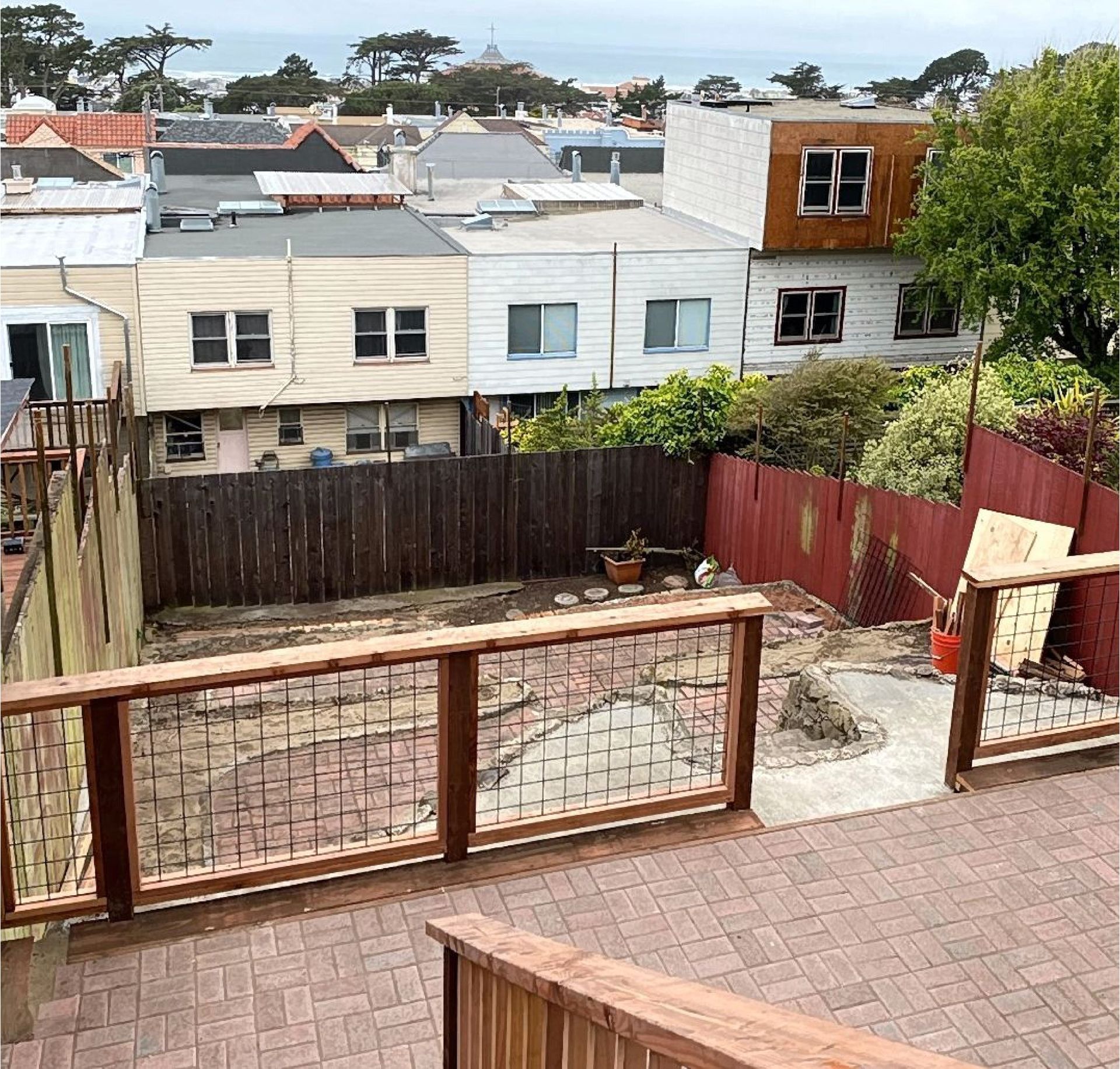 A view of a city from a deck with a wooden railing