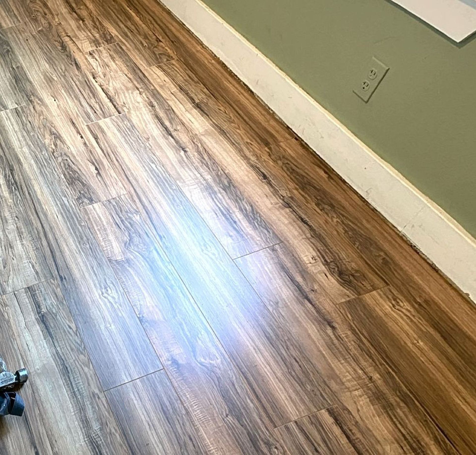 A close up of a wooden floor in a room.