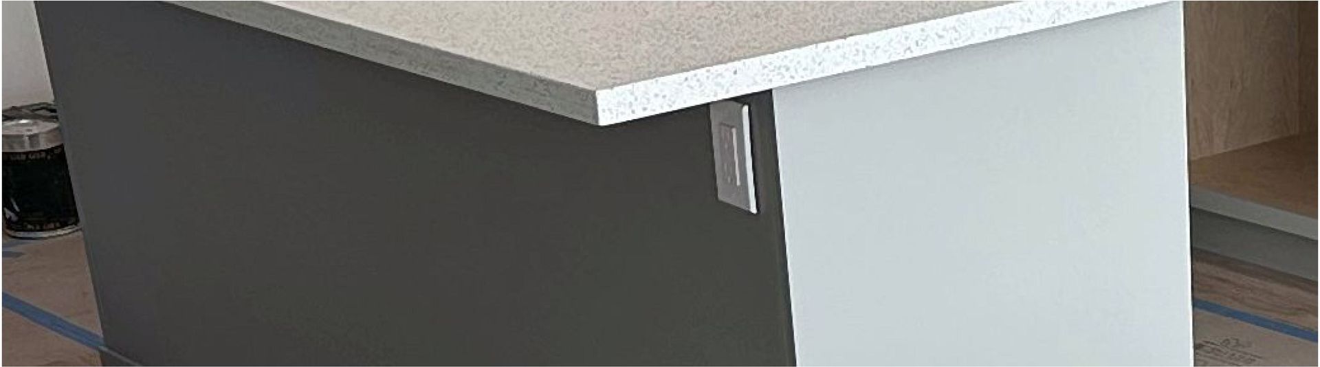 A kitchen island with a granite counter top is being built.