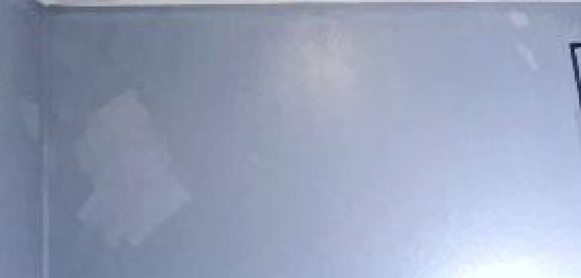 A room with a gray wall and a white ceiling.