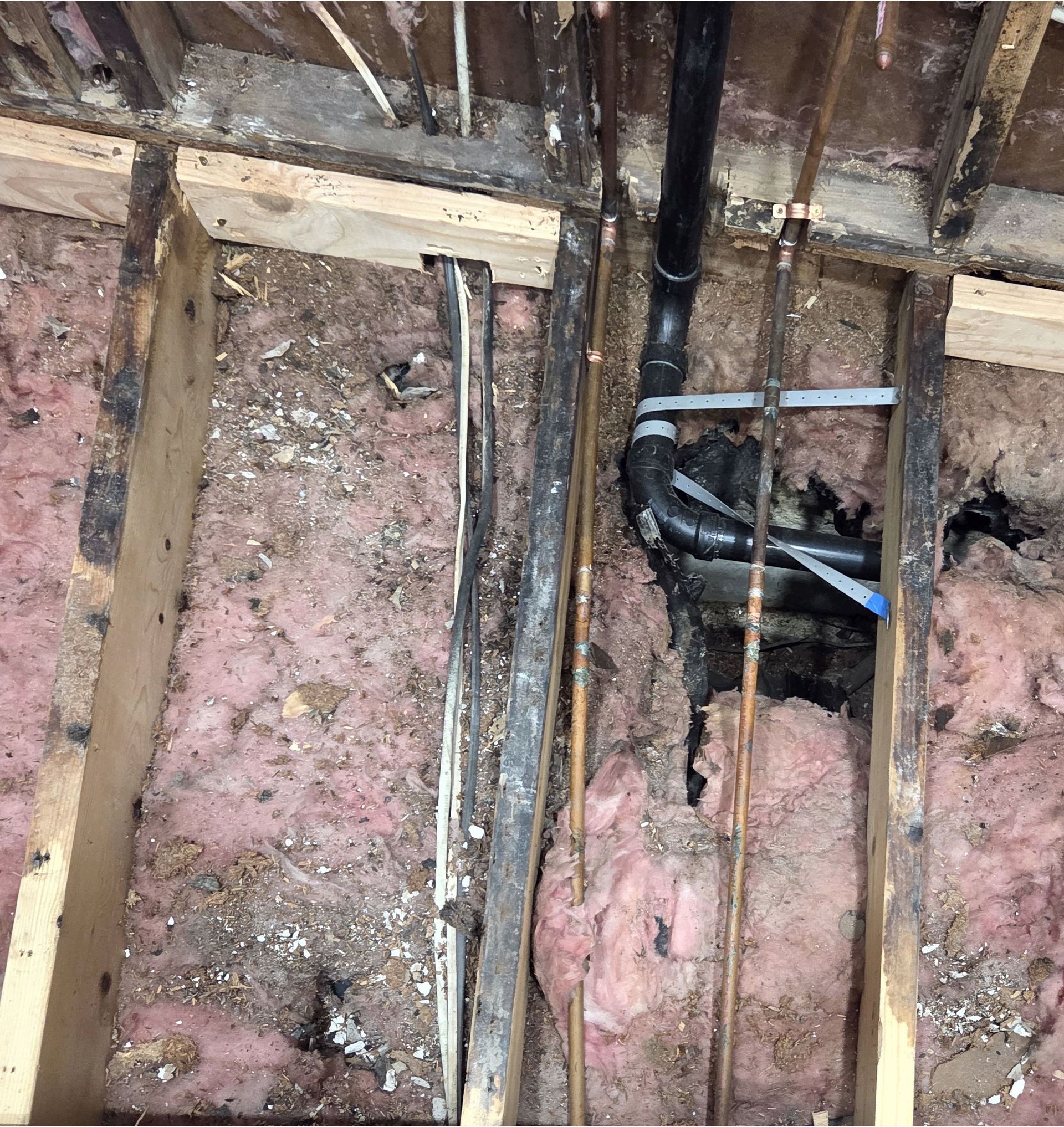 There is a pipe in the ceiling of a building.