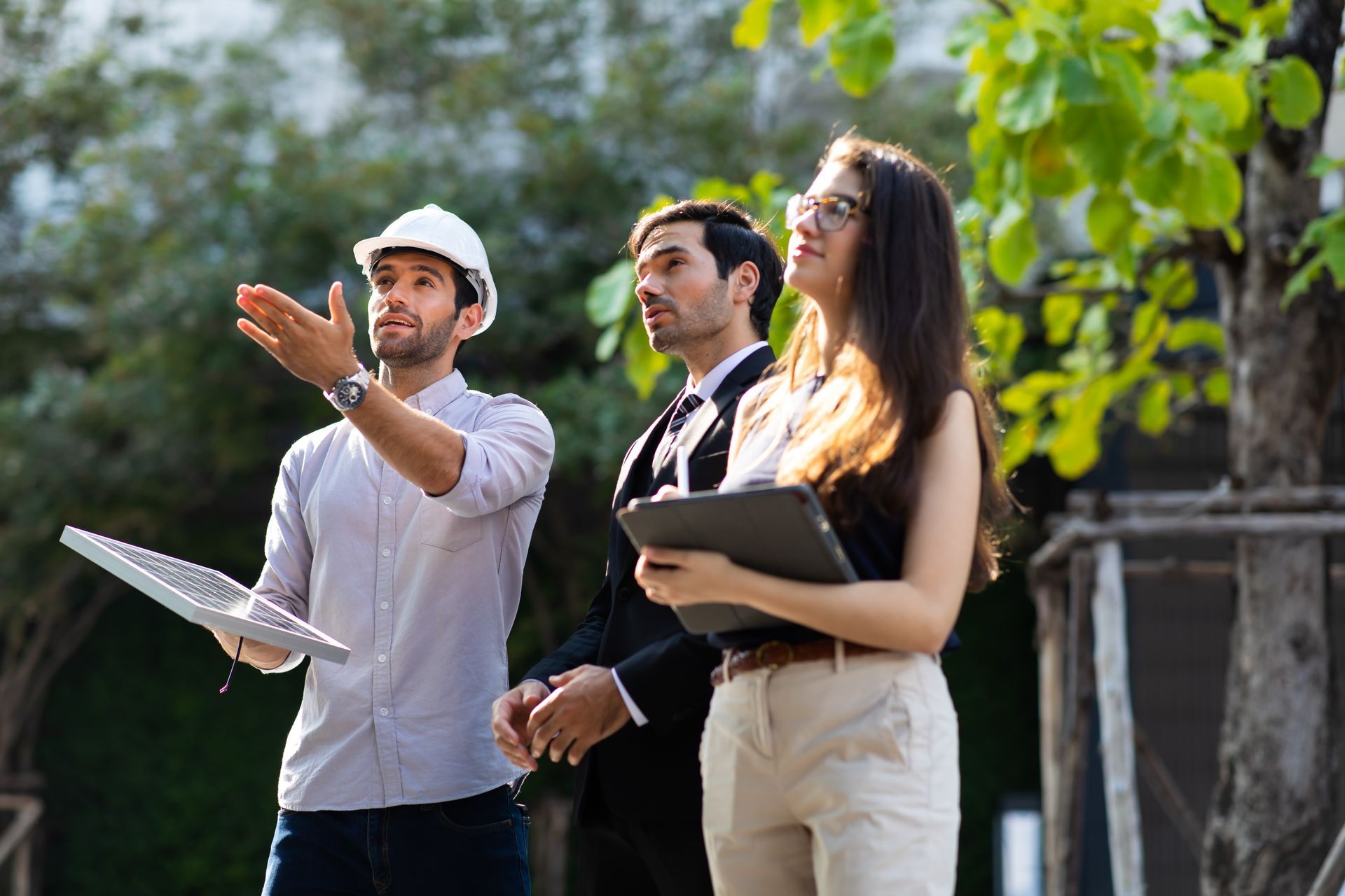 A group of people are standing next to each other in a park.