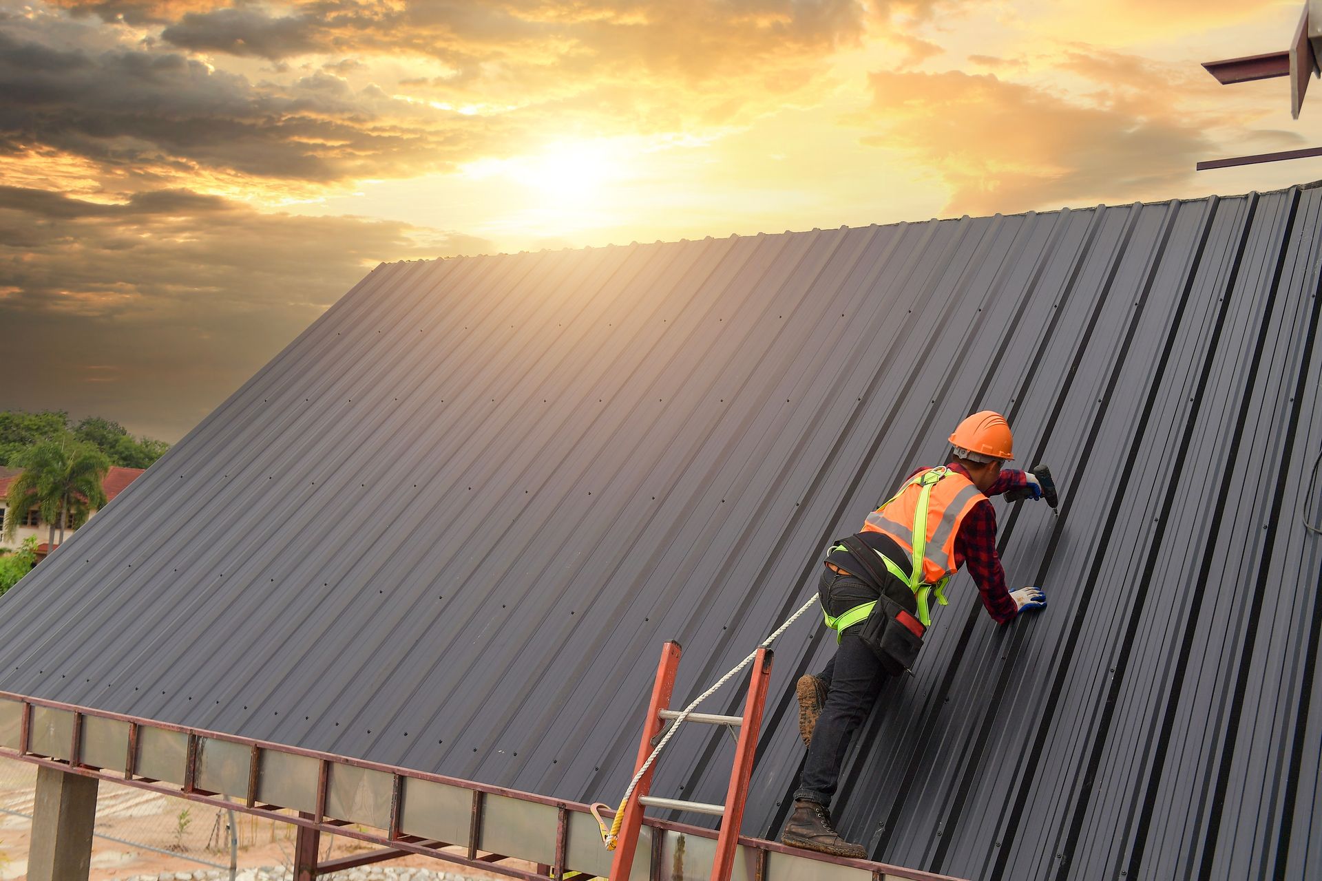 A roof with a skylight and a blue sky in the background.