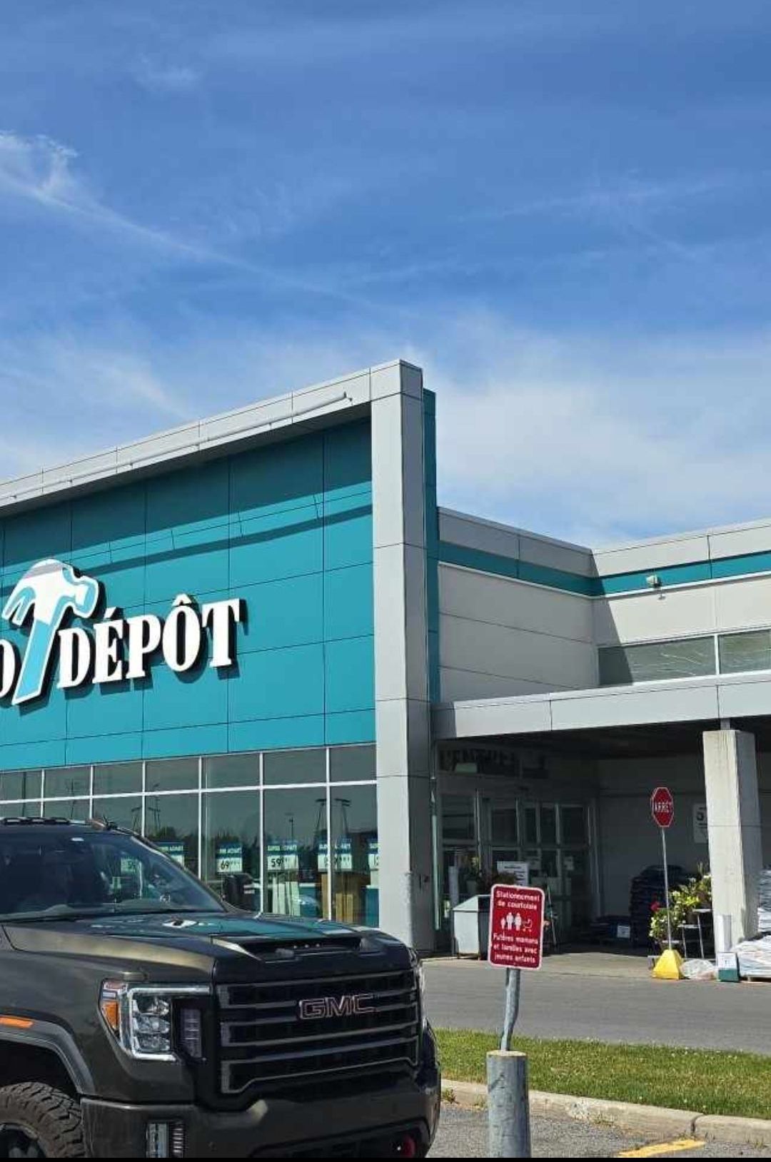 A truck is parked in front of a home depot store.