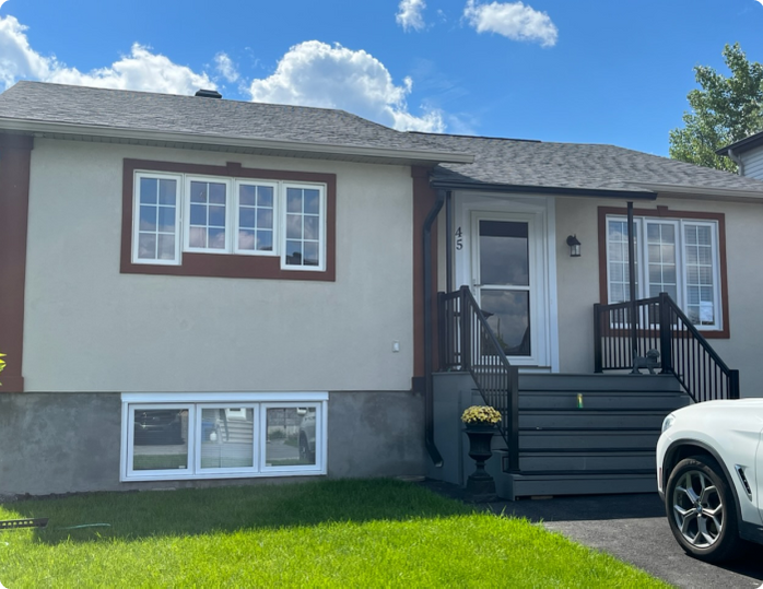 A white car is parked in front of a house