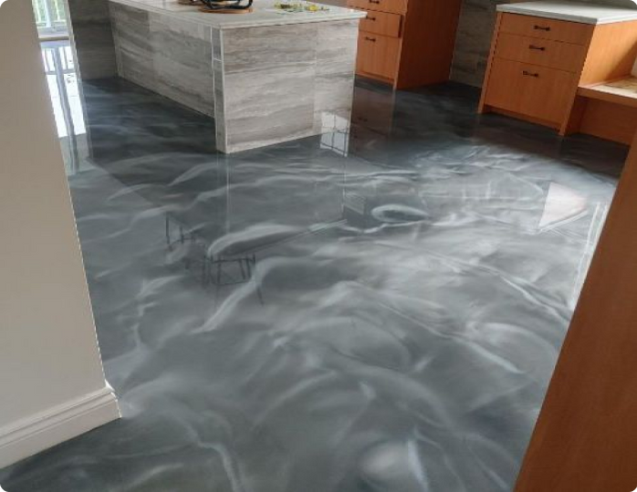 A kitchen with a metallic floor and a large island.