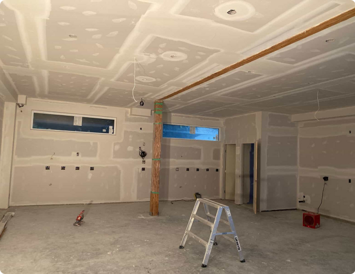 An empty room with a ladder in the middle of it