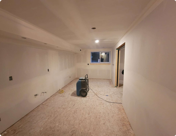 There is a vacuum cleaner in the middle of the room.