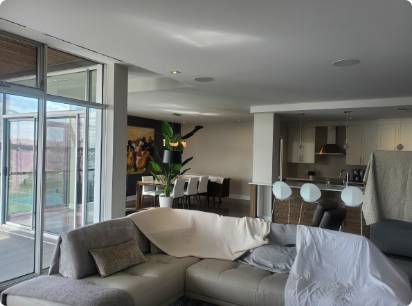 A living room with a couch covered in a white blanket