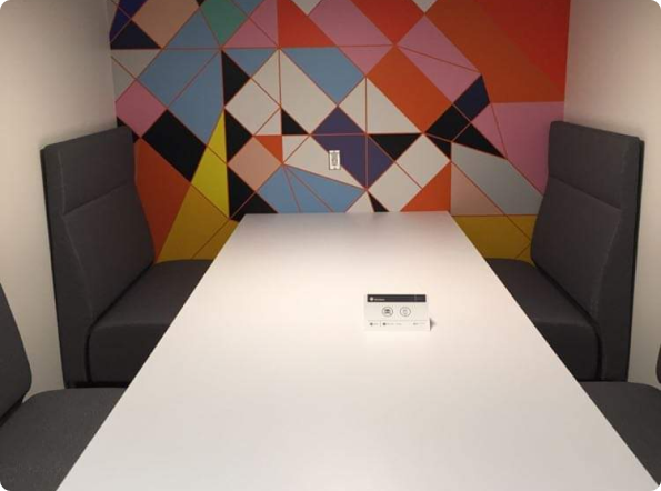 A white table in a room with a colorful wall behind it