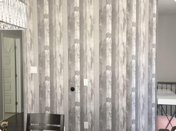 A dining room with a wooden wall and a table and chairs.