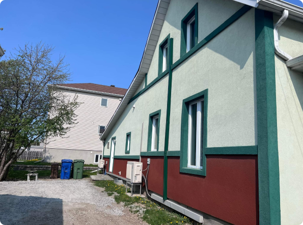 A green and red building with a lot of windows