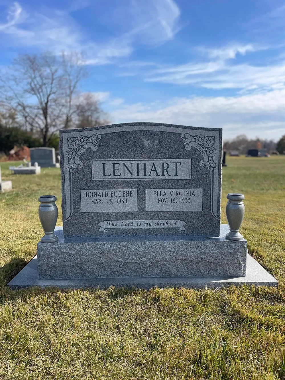 A grey granite headstone marked 