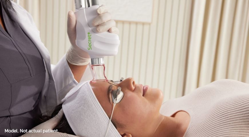 A woman is getting a laser treatment on her face.