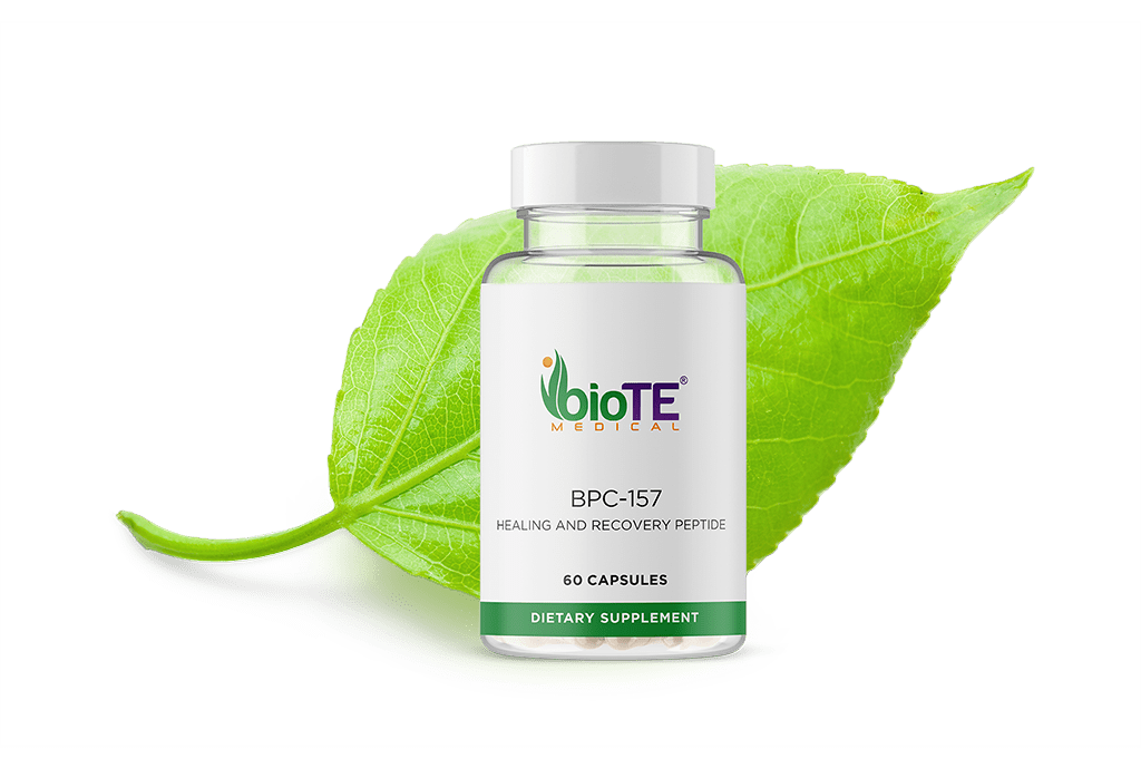 A bottle of pills is sitting on top of a green leaf.