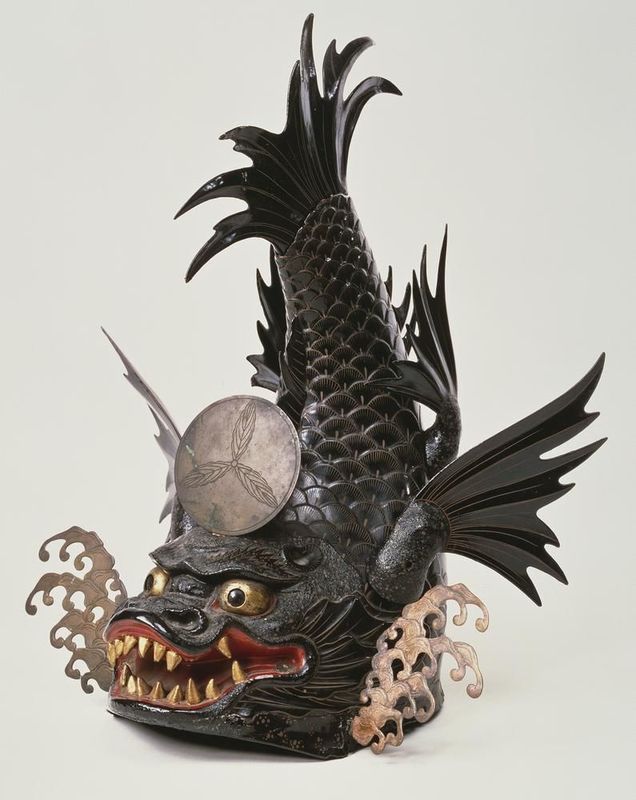 A statue of a dragon with a coin on its head