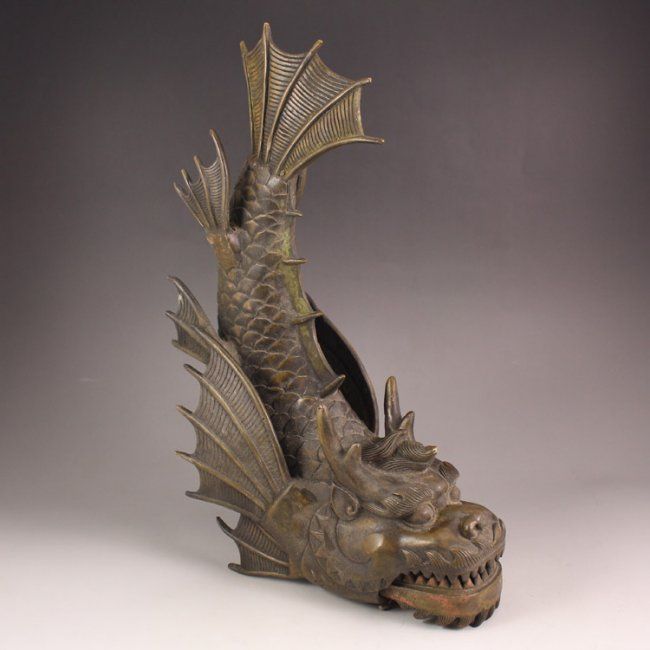 A statue of a dragon with wings and horns