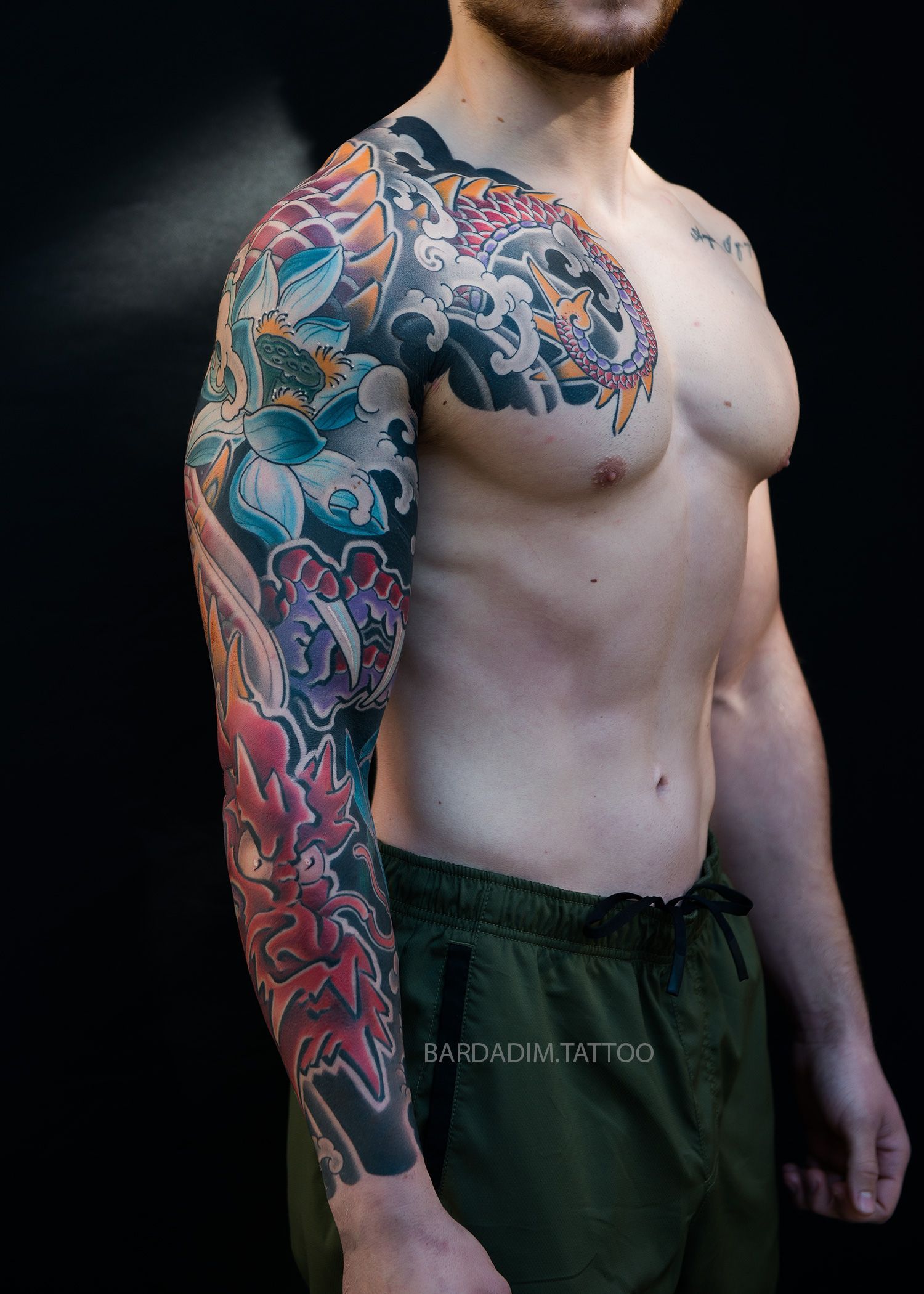 a man with a colorful tattoo on his arm and chest.