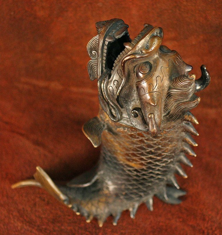 A statue of a fish with its mouth open