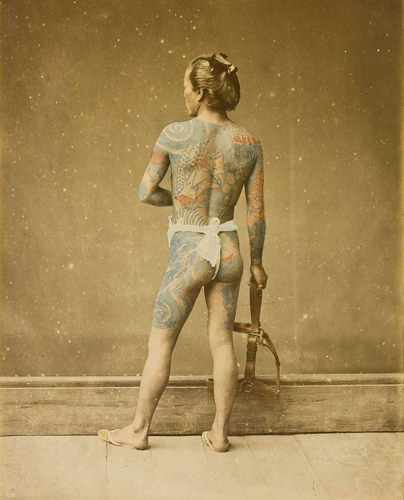 A hand-colored photograph of a tattooed Japanese laborer by Felice Beato, circa 1880s. Via Wikimedia.