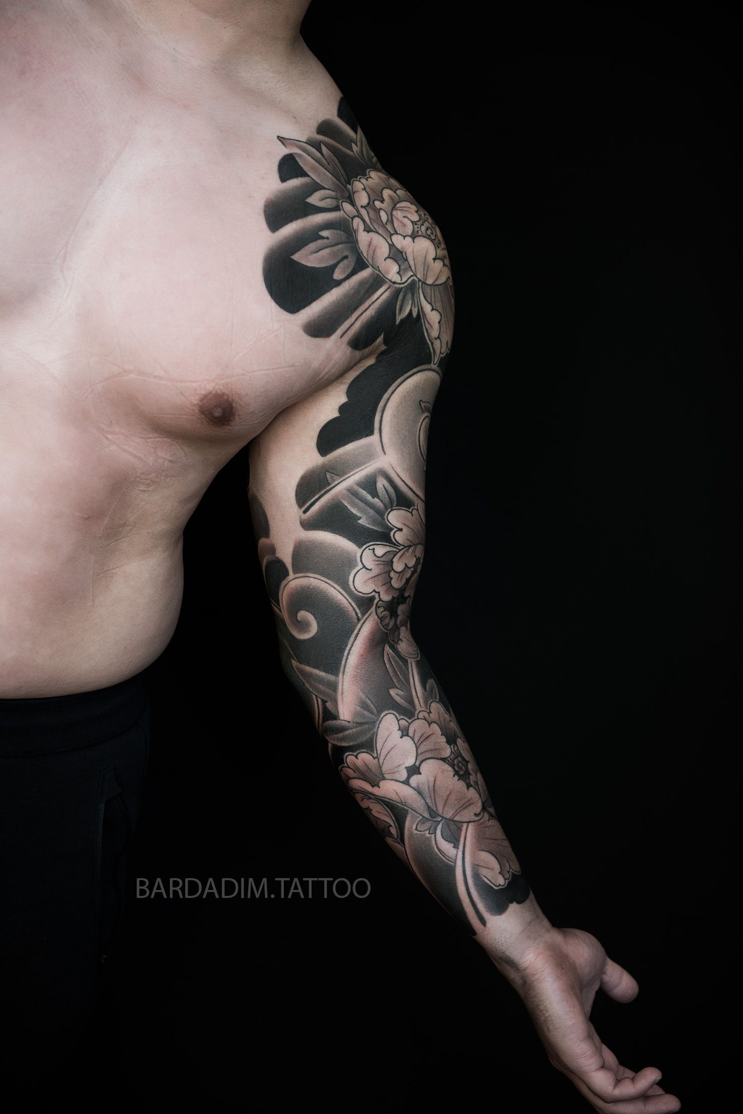 A man with a tattoo on his arm and chest.