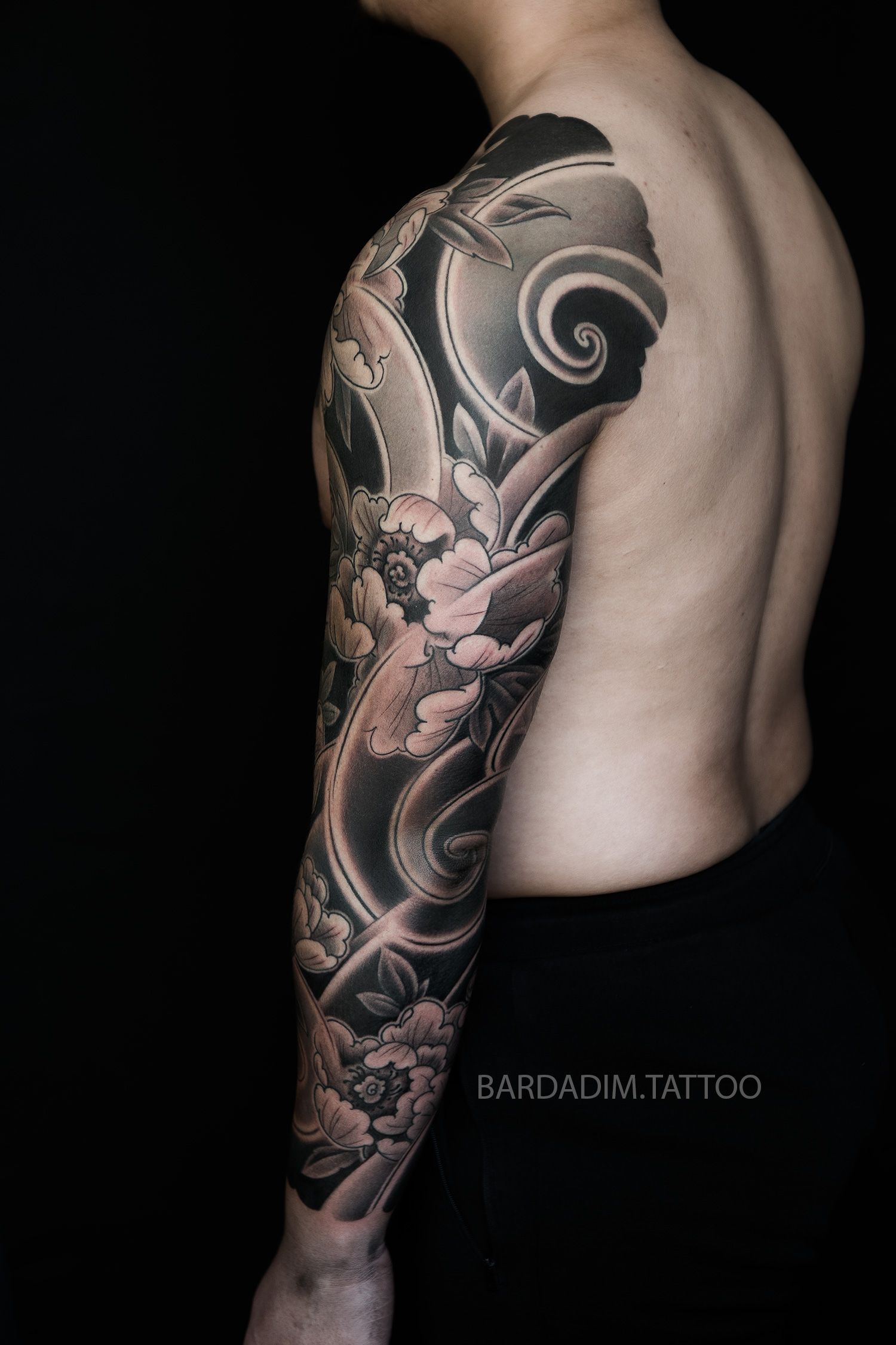 A man with a tattoo on his arm and chest.