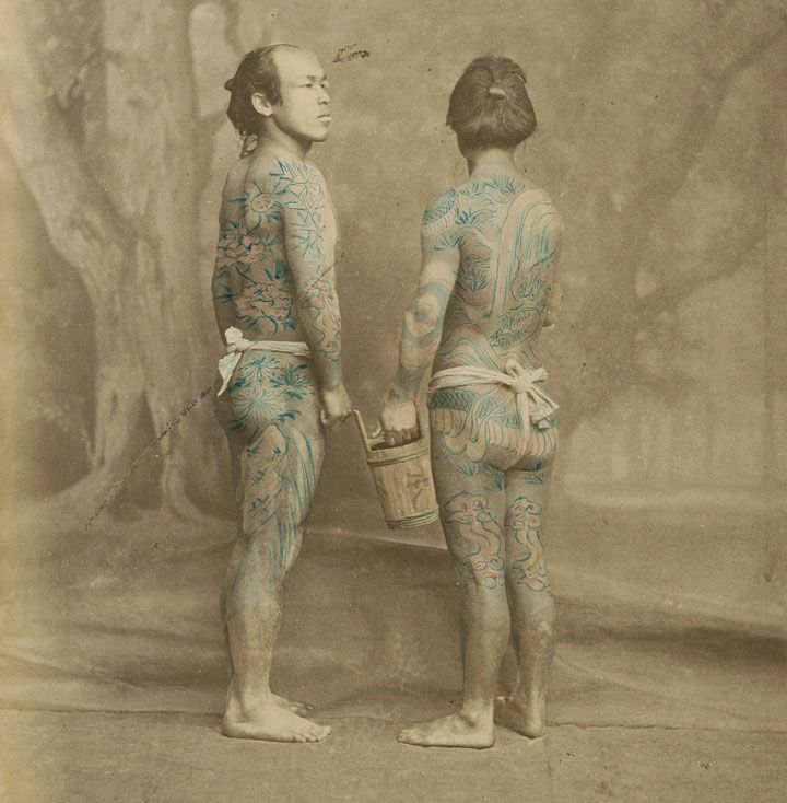 A hand-colored photograph of tattooed Japanese laborers by Felice Beato, circa 1870. Via Wikimedia.