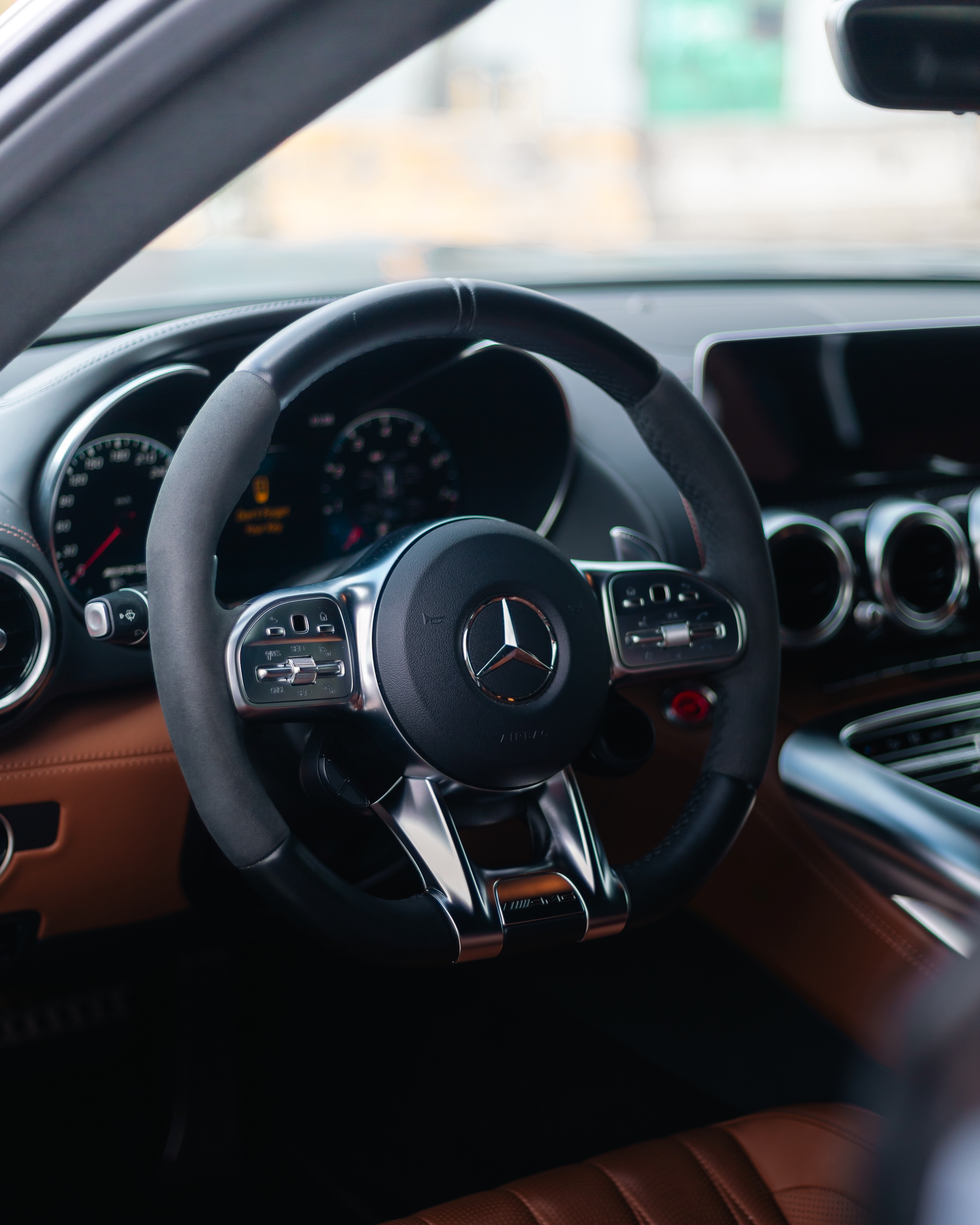 A close up of a steering wheel in a car