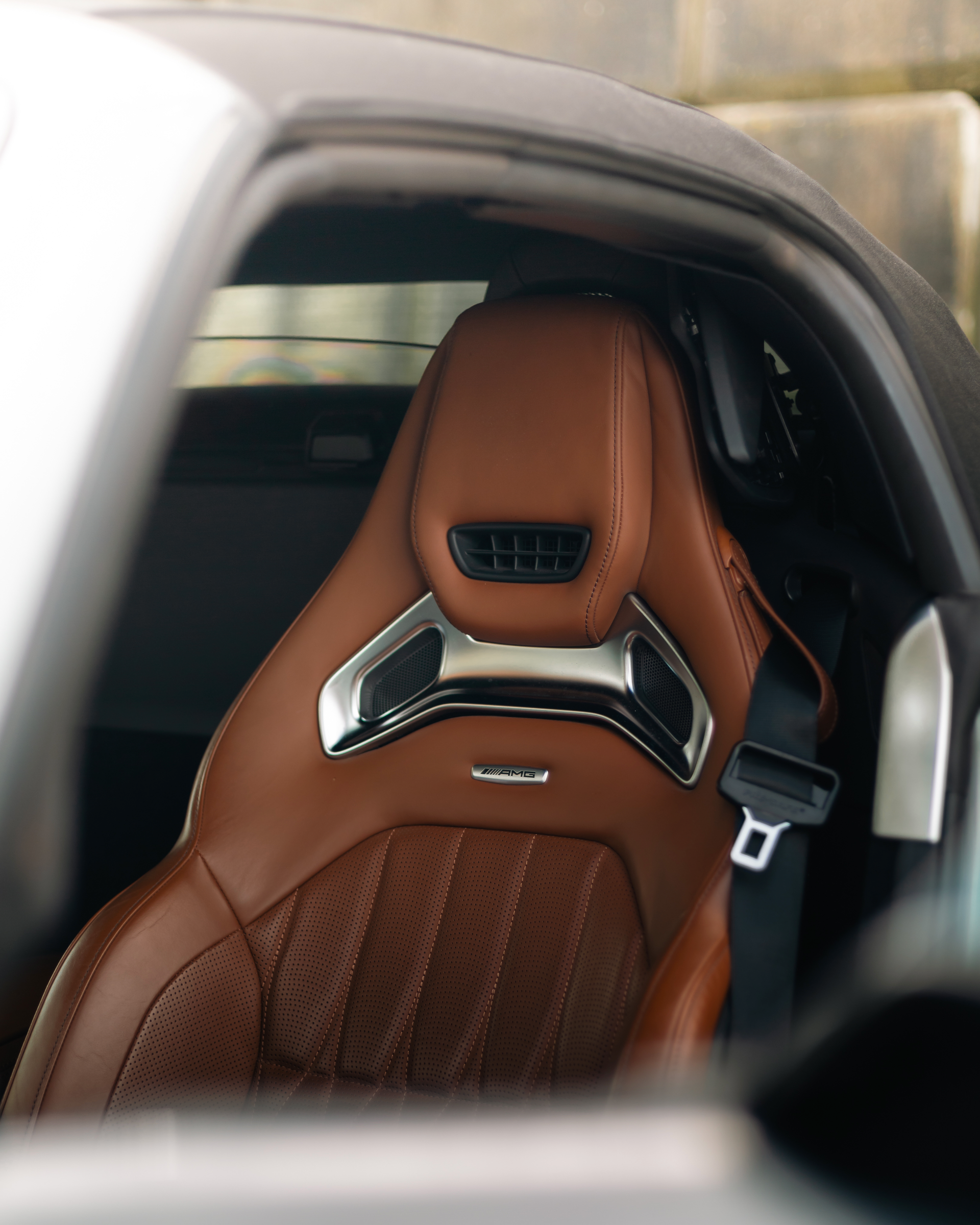 A close up of a brown seat in a car