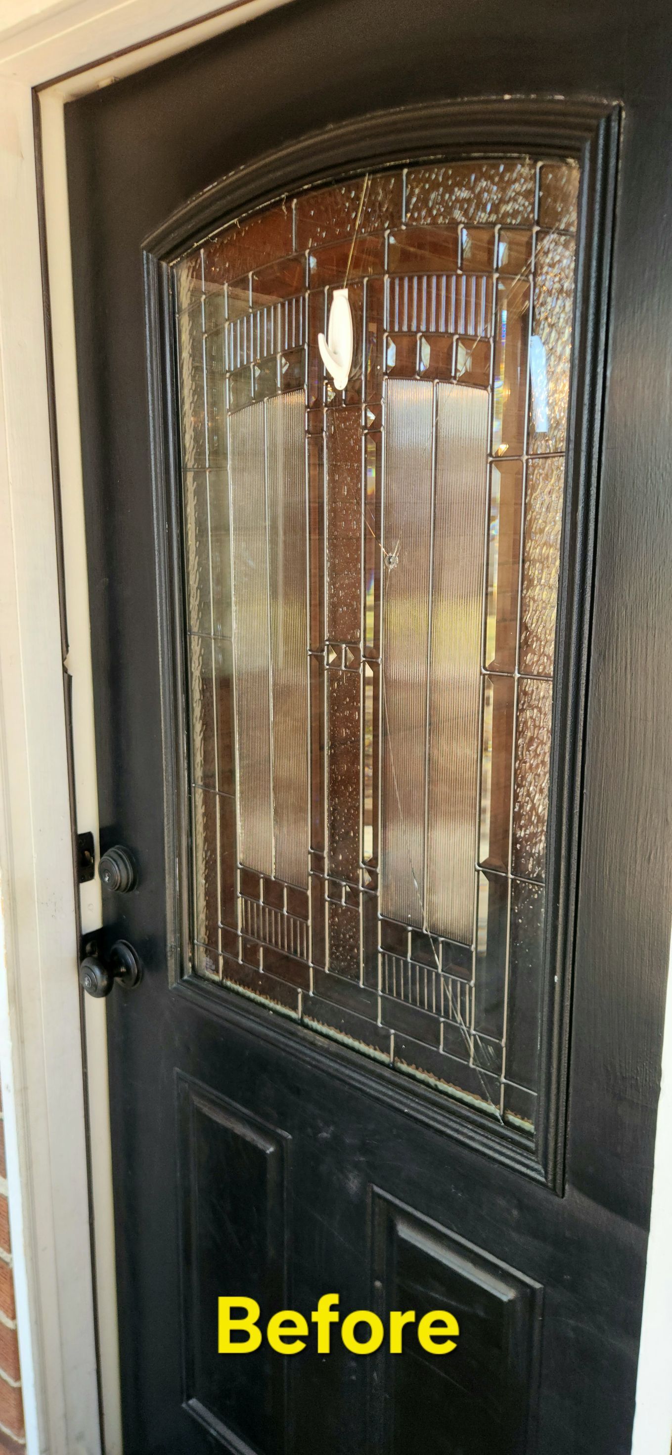 Black door with glass window inset labeled 