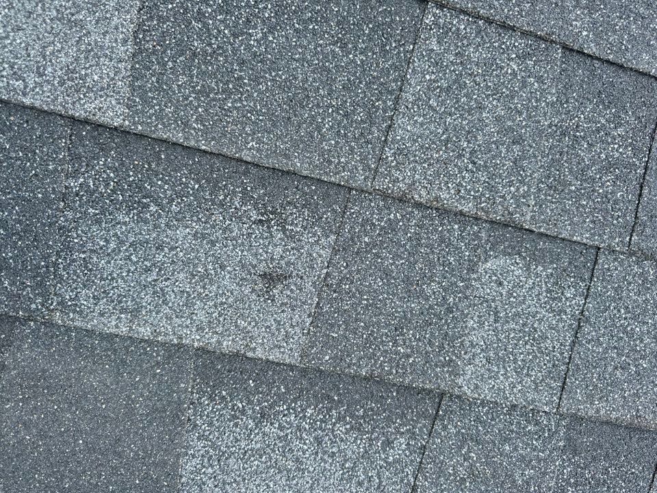 A close up of a roof with a lot of shingles on it.