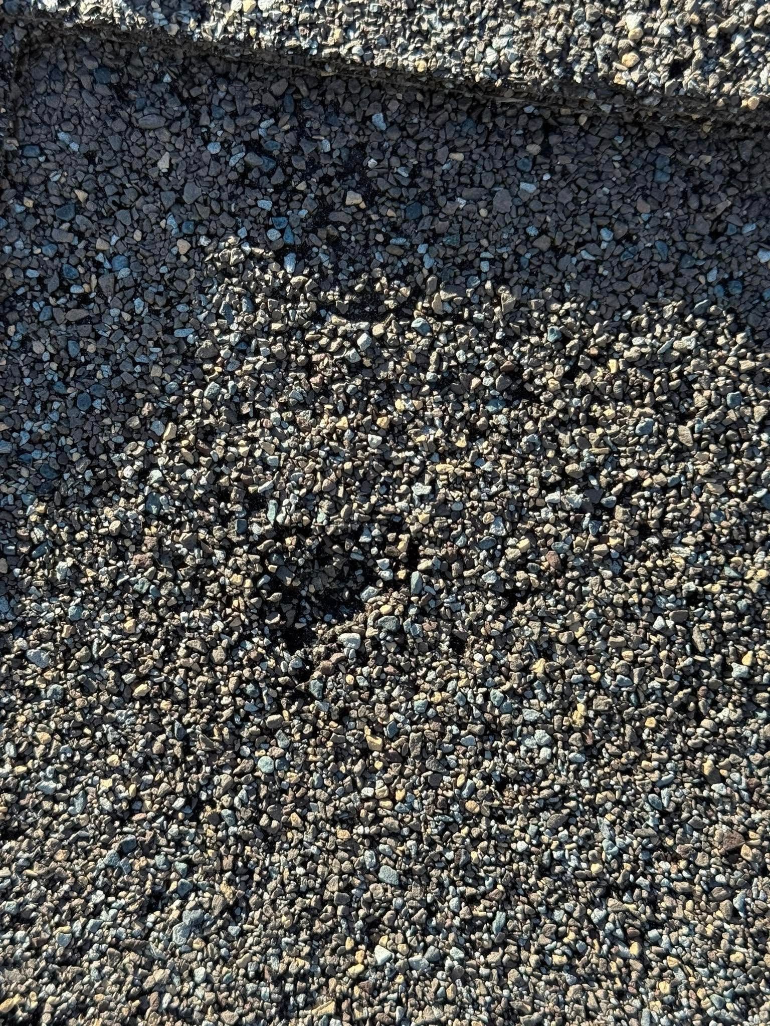 A pile of gravel with a hole in the middle of it.