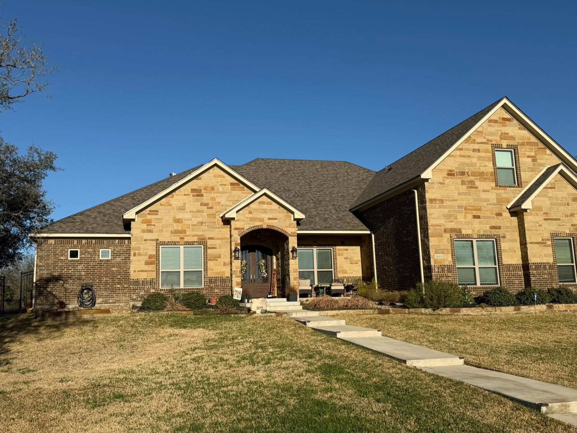 A large brick house with a gray roof